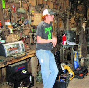 Man stands beside the toaster oven with chestnuts.